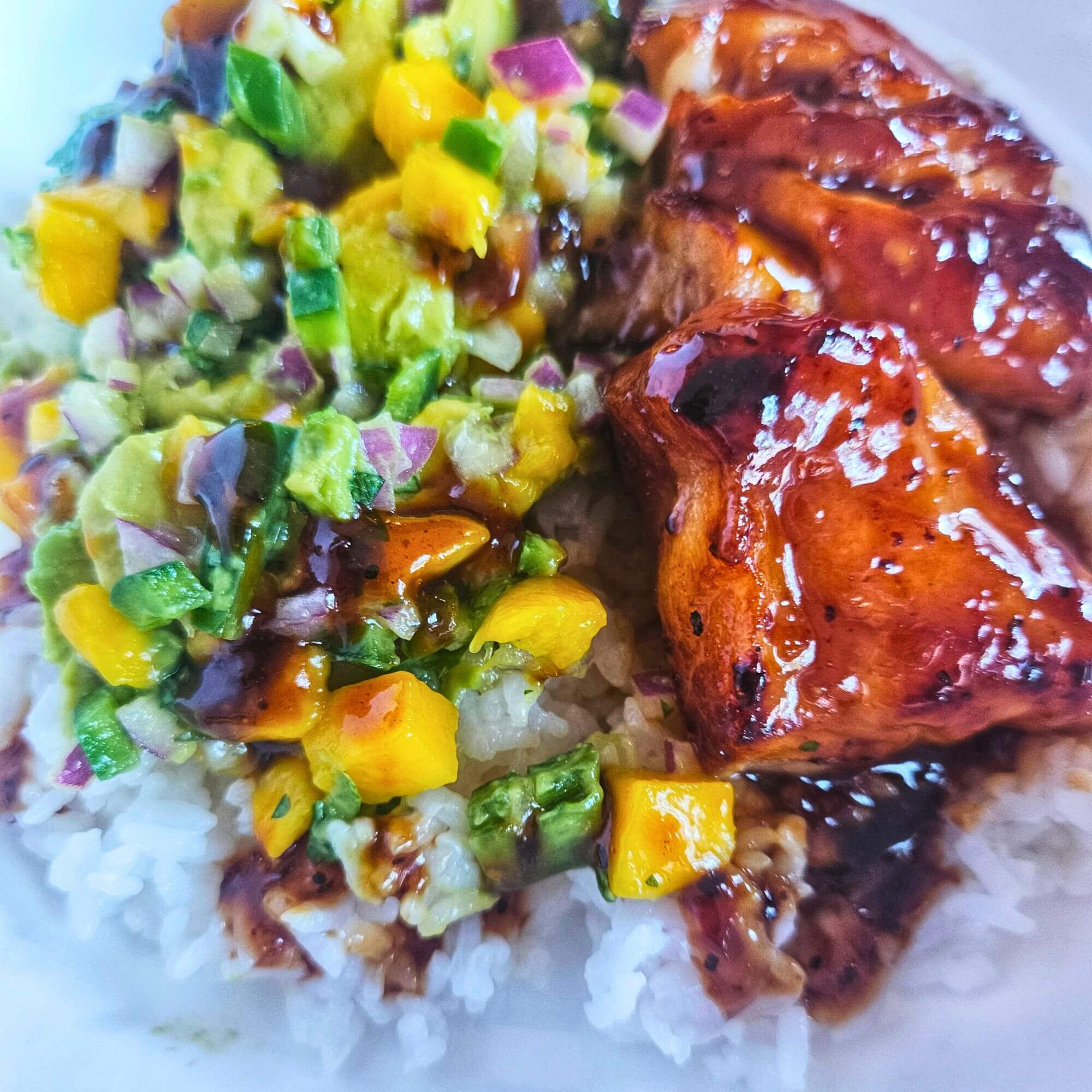 Teriyaki glazed cod over rice with avocado mango salsa.