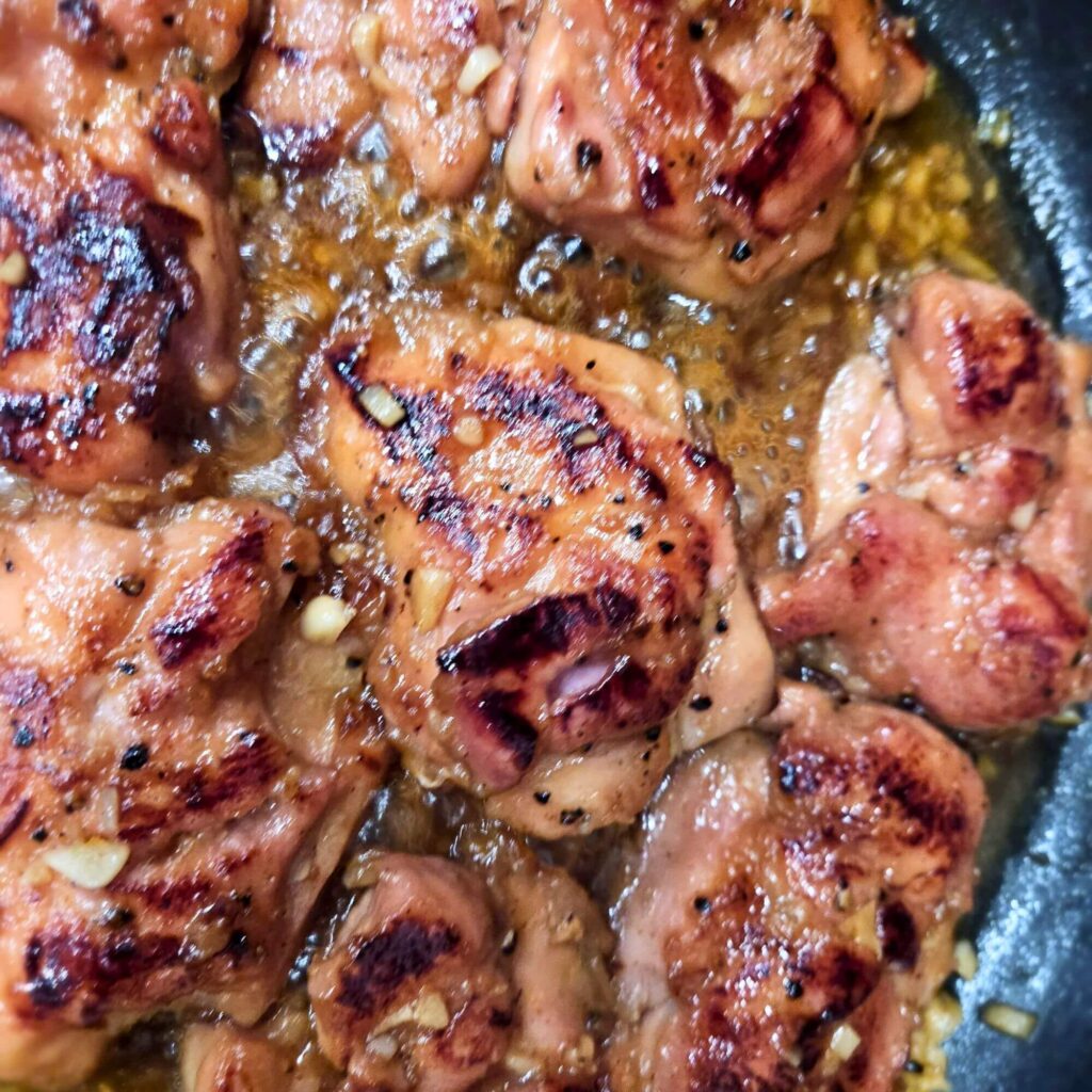Honey garlic chicken FB-instagram Honey garlic chicken being cooked in a skillet.