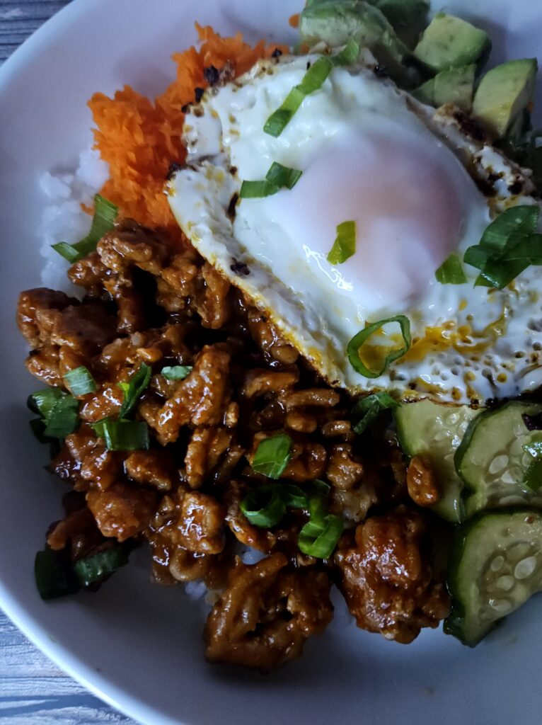 the best gochujang chicken rice bowl with marinated cucumbers