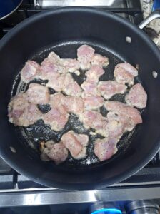 Sweet chili chicken pieces being cooked in the skillet.
