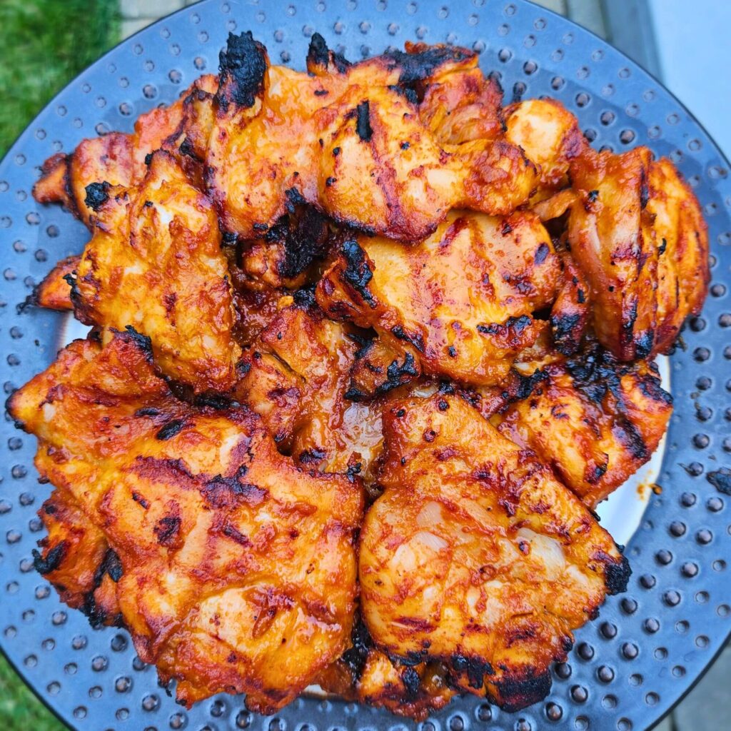 Grilled Korean BBQ chicken thighs after being grilled.