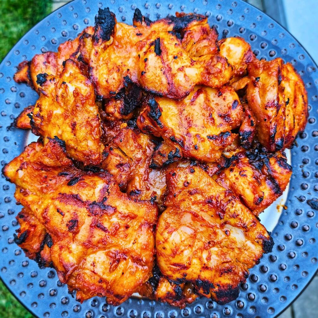 Grilled Korean BBQ chicken thighs after being grilled.