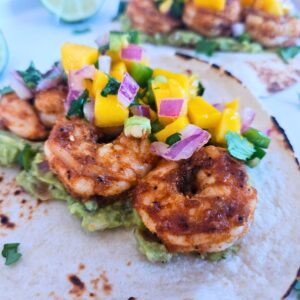 Blackened honey lime shrimp tacos with guacamole and mango salsa.
