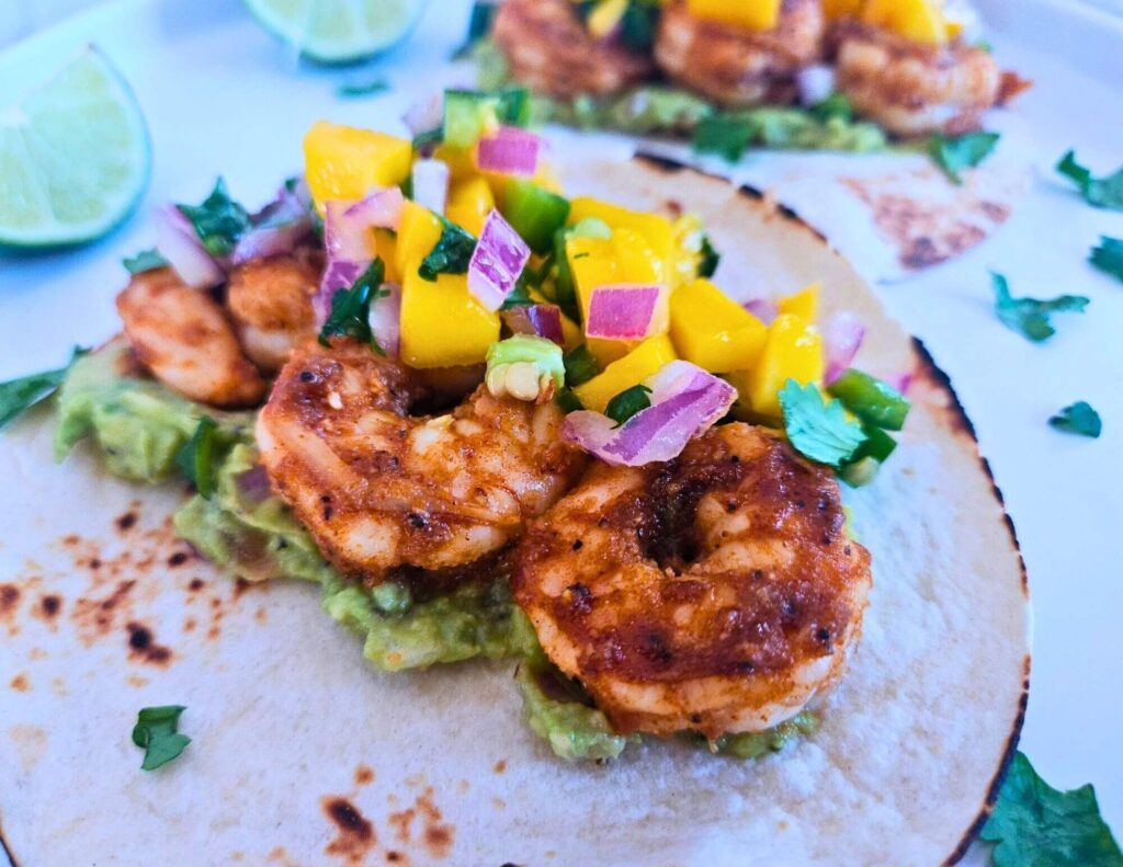 Honey Lime Shrimp Tacos 5 Blackened honey lime shrimp tacos with guacamole and mango salsa.