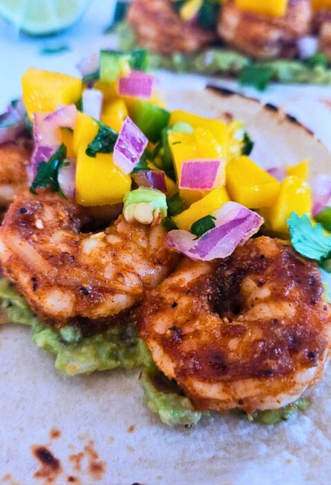 Blackened honey lime shrimp tacos with guacamole and mango salsa.