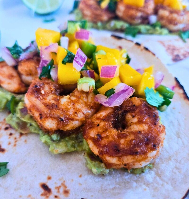 Blackened honey lime shrimp tacos with guacamole and mango salsa.