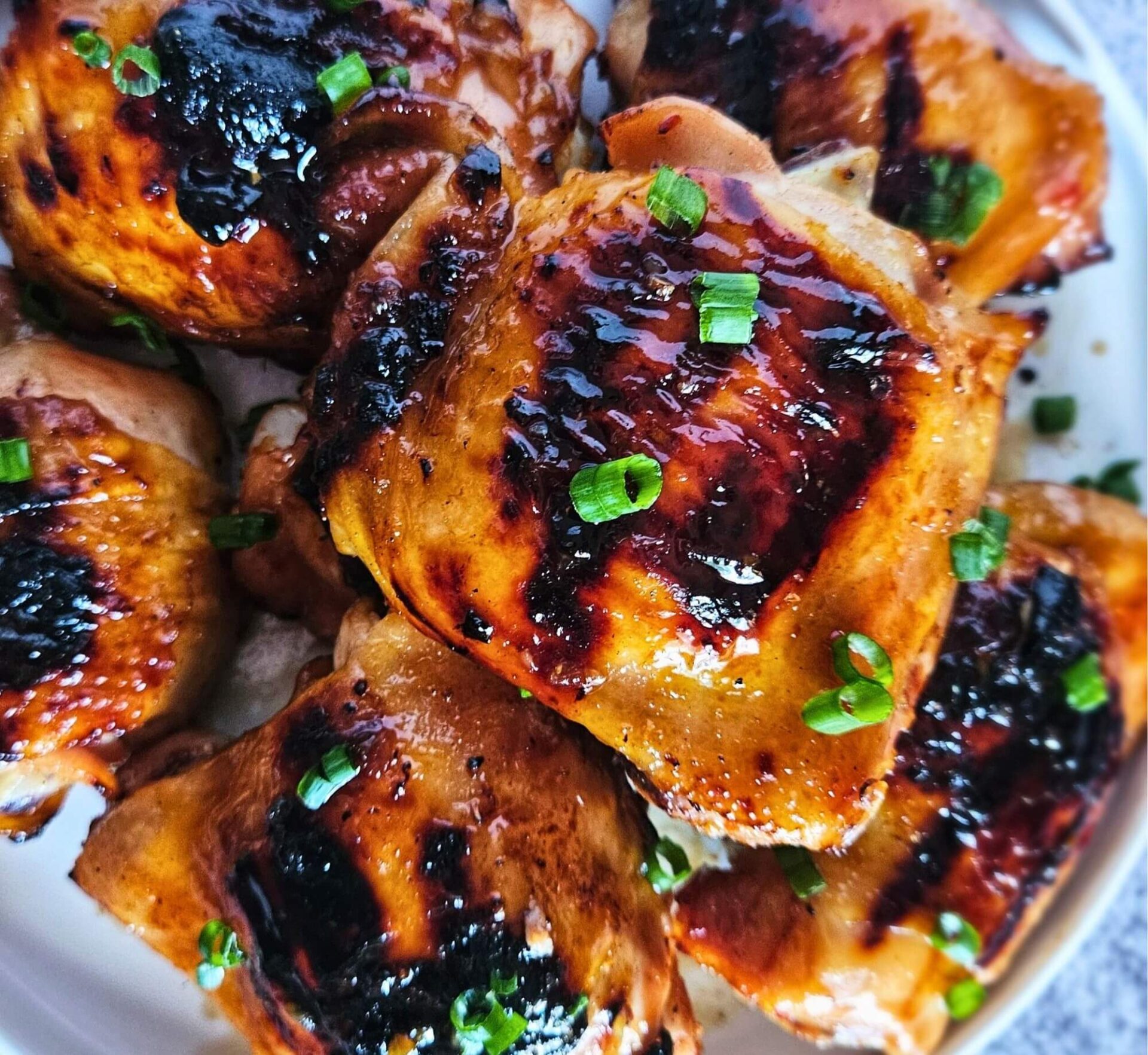 Image of sweet and spicy Thai chicken thighs after being grilled.