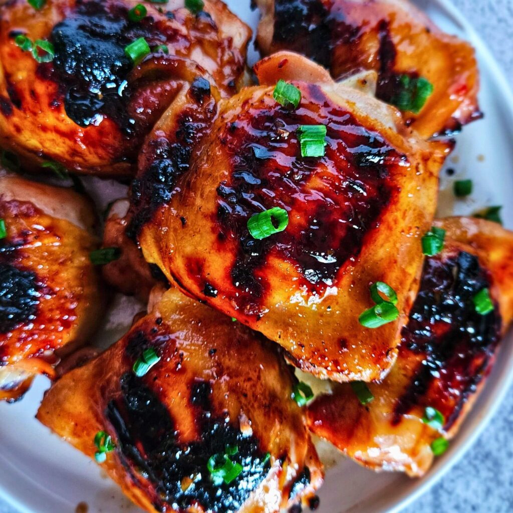 Image of sweet and spicy Thai chicken thighs after being grilled. 