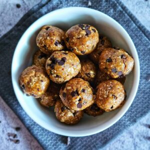 Image of healthy cookie dough date balls being served in a bowl.