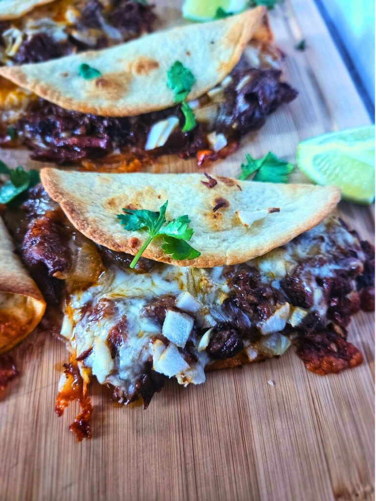 Close up image of crispy barbacoa beef tacos with braised beef. 