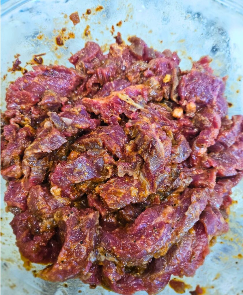 Steak tacos prep 1 Flank steak strips marinating before cooking the steak tacos.