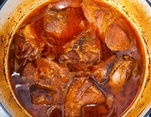 Pork pieces after being braised in the Dutch oven.