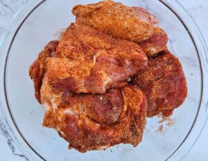 Pork pieces coated in seasonings blend.