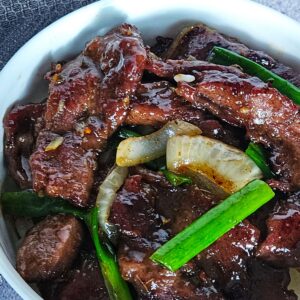 Image of Mongolian beef stir fryer served over white rice.
