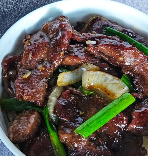 Image of Mongolian beef stir fryer served over white rice.