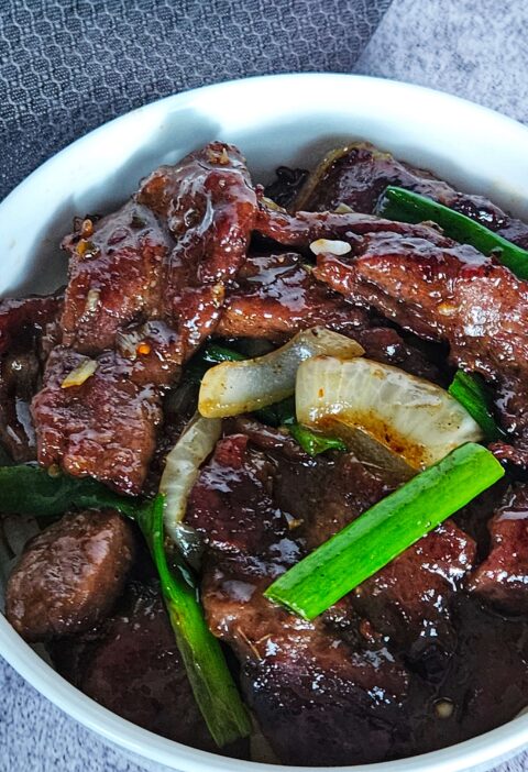 Image of Mongolian beef stir fryer served over white rice.