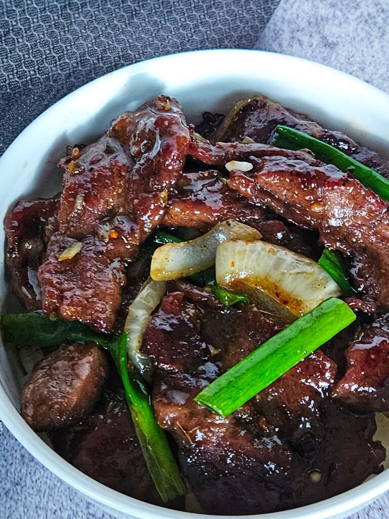 Image of Mongolian beef stir fryer served over white rice.