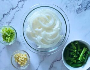Prepared vegetables and aromatics for Mongolian beef stir fry recipe.