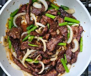 Image of all the ingredients in the skillet after being combined and simmering to thicken the sauce and finalized the Mongolian beef stir fry.