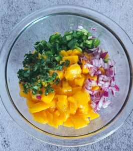 Mango salsa ingredients in a bowl before mixing.