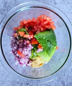 Guacamole ingredients in a bowl before mixing.