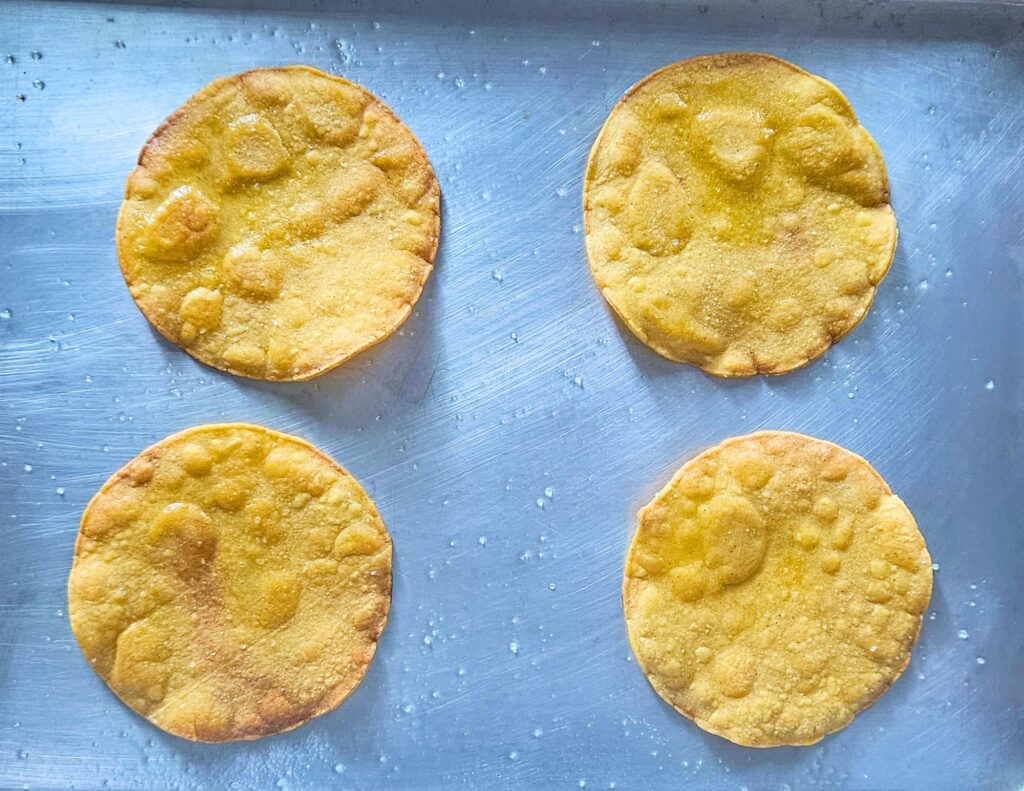 Homemade tostadas after being baked in the oven to make the corn tortilla crispy.