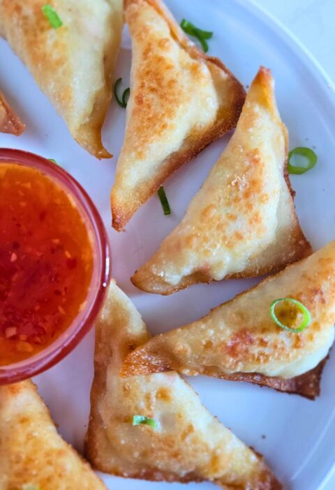 Crispy homemade crab rangoons served with dipping sauce – how to make crab rangoons easily.