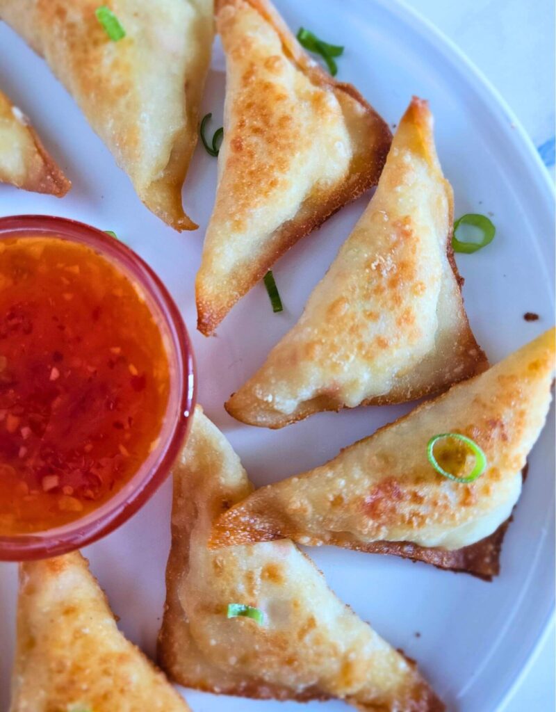 Crispy homemade crab rangoons served with dipping sauce – how to make crab rangoons easily.