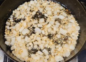 Sauteing garlic and onions in cast iron skillet.