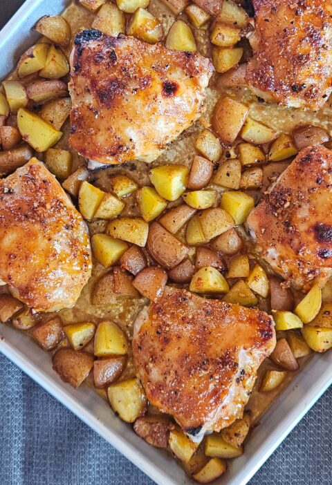 Sheet pan honey mustard chicken thighs with roasted potatoes.