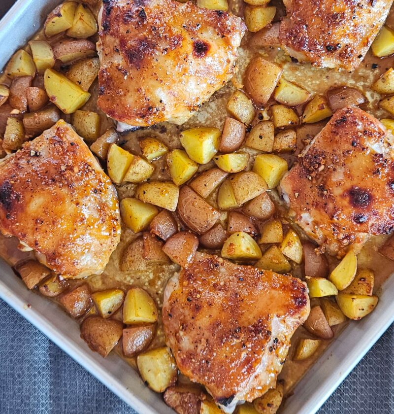 Sheet pan honey mustard chicken thighs with roasted potatoes.
