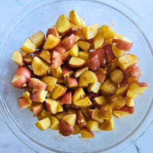 Chopped potatoes in a bowl with honey mustard sauce.