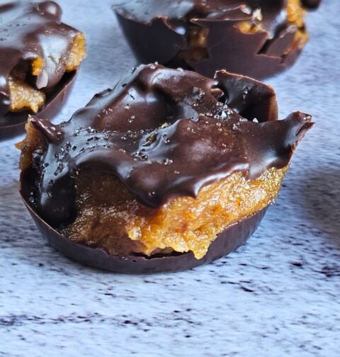 Close up image of dark chocolate covered pumpkin caramel bites.