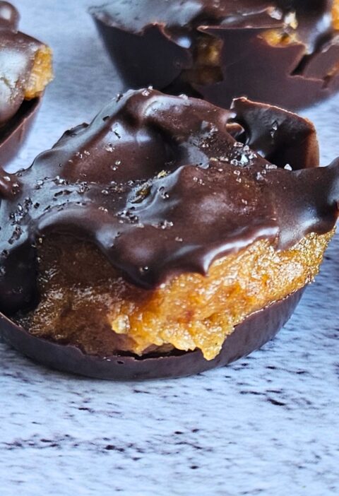 Close up image of dark chocolate covered pumpkin caramel bites.