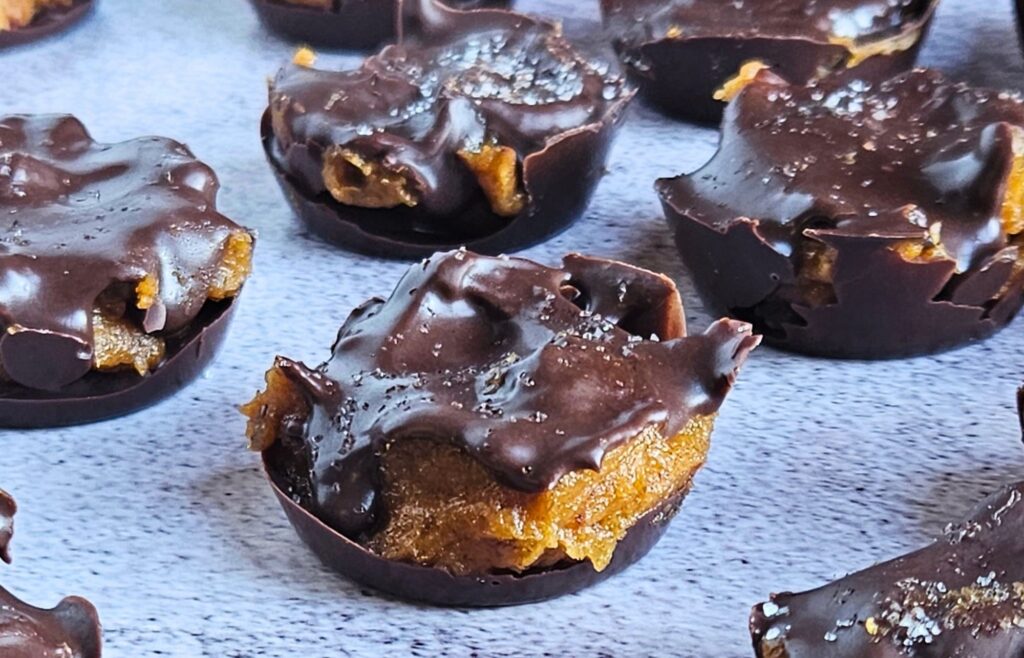 Image of dark chocolate pumpkin caramel bites sprinkled with sea salt. 