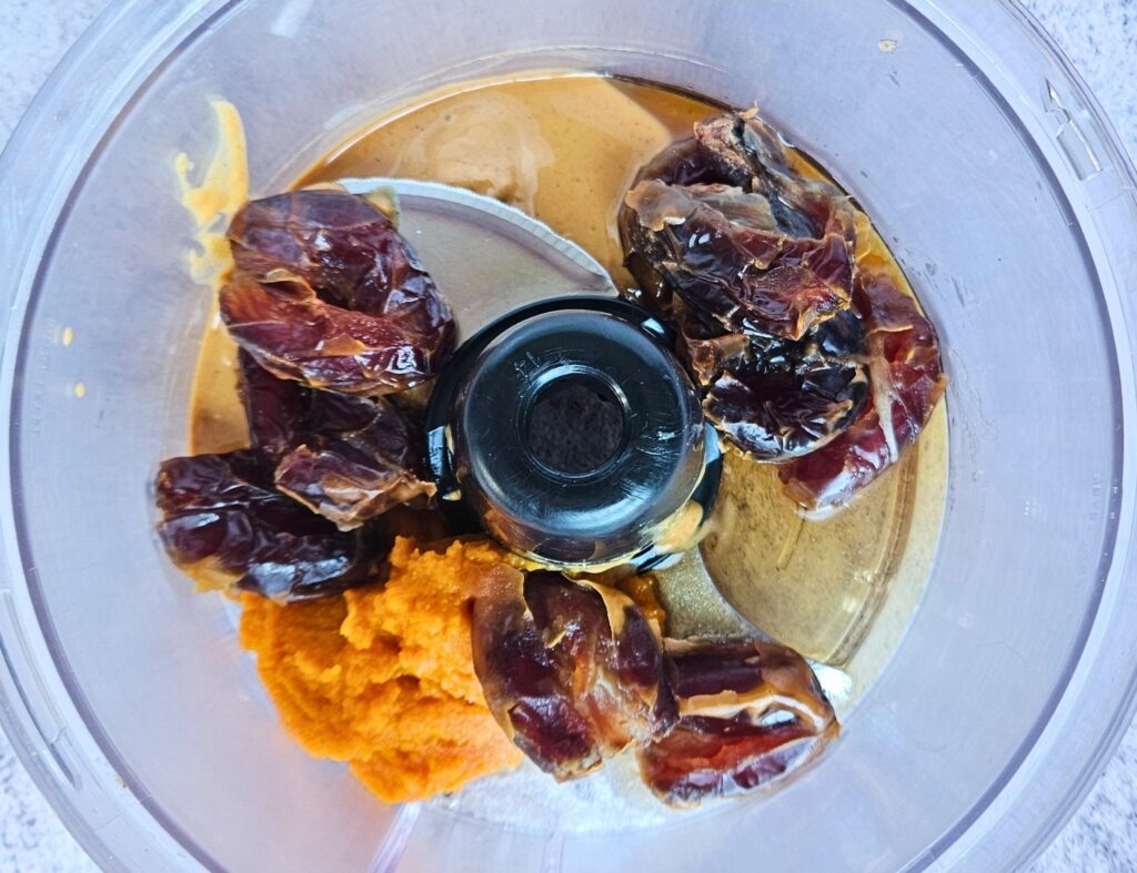 Ingredients for pumpkin caramel in food processor before blending.