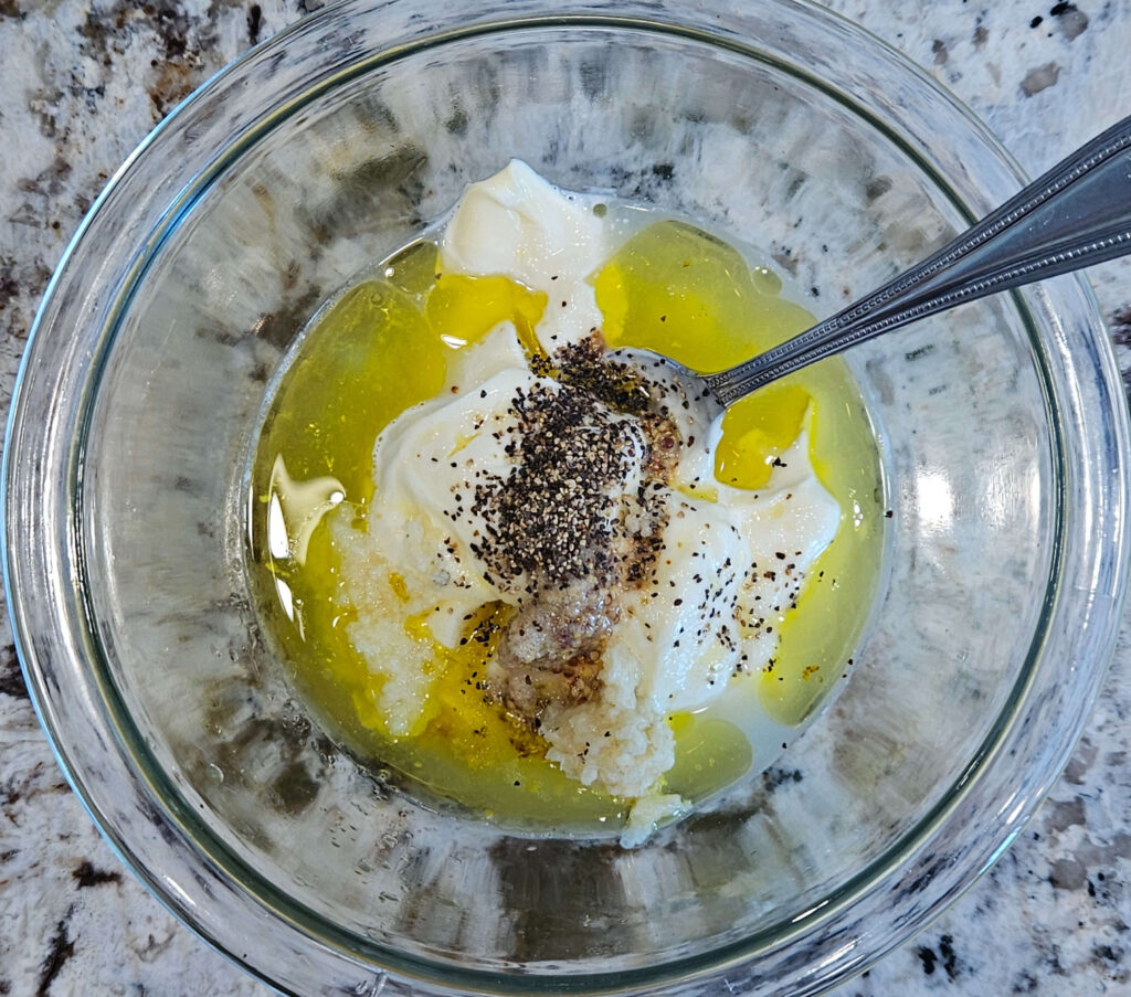 Image of ingredients in a bowl for easy garlic aioli before combining.