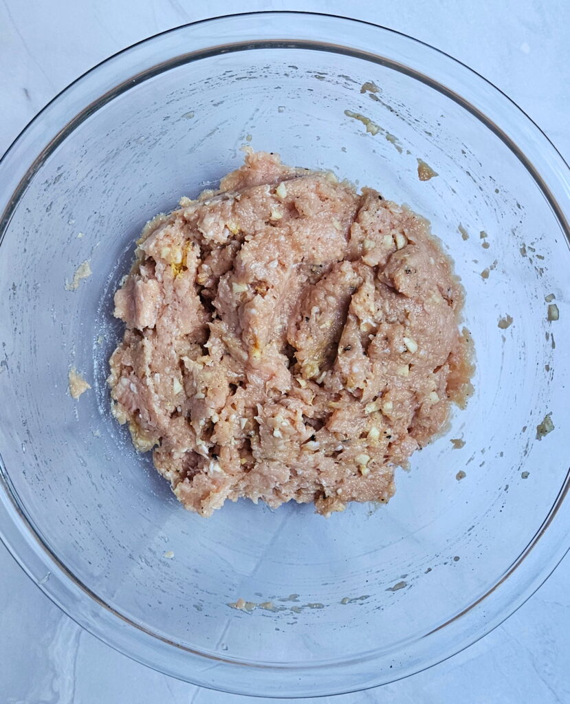 Image of ground chicken taco filling in a bowl for smashed dumpling tacos.