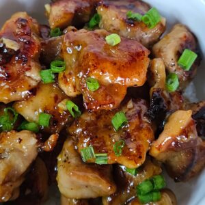 Image of honey ginger chicken stir fry served in a white bowl.