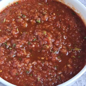 Image of easy chipotle tomato salsa being served in a bowl.