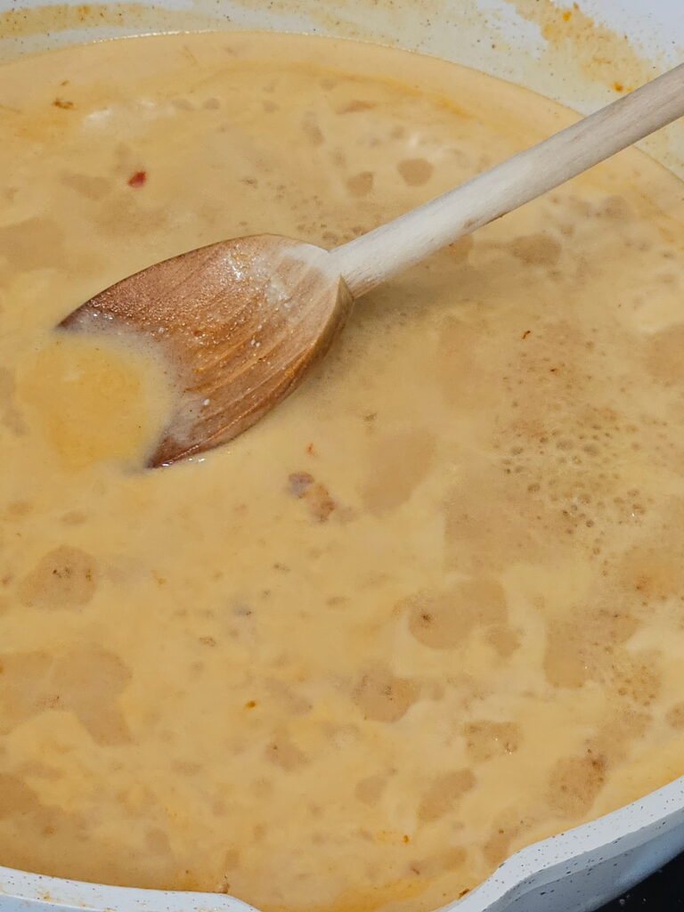 Ramen Prep 2 Image of red chili coconut broth simmering for the base of the ramen recipe.